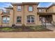 Attractive stucco townhouse with a charming front garden, steps and wrought iron handrail at 7777 E 23Rd Ave # 1406, Denver, CO 80238