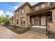 A charming home featuring a welcoming entrance with steps, manicured landscaping, and large windows at 7777 E 23Rd Ave # 1406, Denver, CO 80238