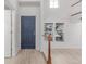 Welcoming foyer with a striking blue door, white walls, and natural light from a window at 7777 E 23Rd Ave # 1406, Denver, CO 80238