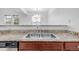 Close up of the kitchen sink with granite countertops and stainless steel dual basin sink at 7777 E 23Rd Ave # 1406, Denver, CO 80238