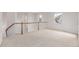 Upstairs landing features wood railing and carpet flooring, providing an open living space at 7777 E 23Rd Ave # 1406, Denver, CO 80238