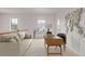 Bright and airy living room with comfortable sofa, desk, and natural light from windows at 7777 E 23Rd Ave # 1406, Denver, CO 80238