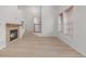 Bright and airy living space with a fireplace, staircase, and natural light through the windows at 7777 E 23Rd Ave # 1406, Denver, CO 80238