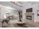 Bright living room with a cozy fireplace, TV and dining area with modern chandelier at 7777 E 23Rd Ave # 1406, Denver, CO 80238