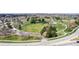 Aerial view of park which features a large open grass field, surrounded by walking trails and mature trees at 7777 E 23Rd Ave # 1406, Denver, CO 80238
