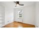 Cozy bedroom with wood floors, a built-in bookshelf, and a window offering natural light at 1165 Krameria St, Denver, CO 80220