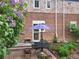 Charming patio features a table, chairs, and a vibrant garden with colorful flowers at 1165 Krameria St, Denver, CO 80220