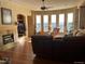 Living room with a fireplace, sectional sofa, and hardwood floors at 587 Brookside Dr, Longmont, CO 80504