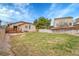 Large grassy backyard featuring a wood fence, patio, and a charming, well-maintained home at 5162 Hubert St, Parker, CO 80134