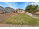 Large backyard with grass, fence, patio with lounge seating, and neighboring houses at 5162 Hubert St, Parker, CO 80134