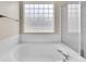 Clean bathroom featuring a large soaking tub, glass block window, and a tiled shower at 5162 Hubert St, Parker, CO 80134