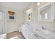 Bright bathroom with double sinks, tile floors, and a separate shower at 5162 Hubert St, Parker, CO 80134