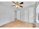 Bedroom with ceiling fan, wood floors, closet and view to a doorway at 5162 Hubert St, Parker, CO 80134