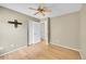 Neutral bedroom boasts wood floors, ceiling fan, closet and wall mount for TV at 5162 Hubert St, Parker, CO 80134