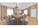 Dining area with a wooden table, chairs, and a chandelier, complemented by neutral wall colors and decor at 5162 Hubert St, Parker, CO 80134
