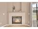 Close up view of tile fireplace in the living room with a mantle and gas logs at 5162 Hubert St, Parker, CO 80134