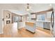 Open concept kitchen with white cabinets, stainless steel appliances, kitchen island and hardwood floors at 5162 Hubert St, Parker, CO 80134