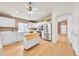 Bright kitchen with white cabinets, stainless steel appliances, kitchen island and hardwood floors at 5162 Hubert St, Parker, CO 80134