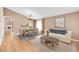 Bright living room with neutral walls, a dining area with a chandelier, and a comfortable sofa at 5162 Hubert St, Parker, CO 80134