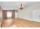 Open living room featuring hardwood floors, natural light, a chandelier and neutral walls at 5162 Hubert St, Parker, CO 80134