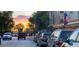 Picturesque town view at sunset, showcasing a street with parked cars and a patriotic American flag at 5162 Hubert St, Parker, CO 80134