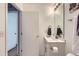 Updated bathroom features a modern vanity and large mirror at 4520 Andes St, Denver, CO 80249