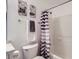 Bright bathroom features a shower with striped curtain and decor at 4520 Andes St, Denver, CO 80249
