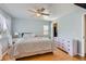 Bright and airy bedroom with hardwood floors, a ceiling fan, and a large window providing ample natural light at 4520 Andes St, Denver, CO 80249