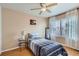 Cozy bedroom with natural light, ceiling fan, and hardwood floors at 4520 Andes St, Denver, CO 80249
