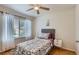 Cozy bedroom with hardwood floors, a bed with decorative pillows, a window, and natural light at 4520 Andes St, Denver, CO 80249