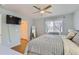 Serene bedroom features hardwood floors, a ceiling fan, a large window, and a cozy, inviting atmosphere at 4520 Andes St, Denver, CO 80249