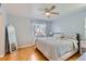Relaxing bedroom with a ceiling fan, a window with sheer curtains, and warm hardwood floors at 4520 Andes St, Denver, CO 80249