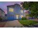 Two-story home featuring a well-maintained lawn and a one-car garage at dusk at 4520 Andes St, Denver, CO 80249