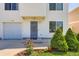 Well-maintained house featuring a lush lawn and blooming flower garden at 4520 Andes St, Denver, CO 80249