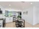 Modern kitchen featuring white cabinetry, stainless steel appliances, and an eat-in island with seating at 4520 Andes St, Denver, CO 80249