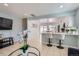 Bright, open-concept living space, featuring modern tiled floors, a breakfast bar, and recessed lights at 4520 Andes St, Denver, CO 80249