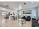 Open living space with tiled flooring, white kitchen, breakfast bar, and recessed lighting at 4520 Andes St, Denver, CO 80249