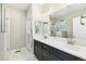 Elegant bathroom with double sink vanity, walk-in shower, and contemporary fixtures for a spa-like experience at 7812 Inverness Blvd, Englewood, CO 80112