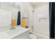 Bright bathroom featuring a combination tub/shower and a sleek vanity with white marble top at 7812 Inverness Blvd, Englewood, CO 80112