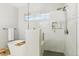 Modern bathroom featuring a glass-enclosed shower and a soaking tub with sleek fixtures at 7812 Inverness Blvd, Englewood, CO 80112