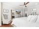 Bright bedroom with a ceiling fan, TV, and ensuite bathroom access creating a relaxing retreat at 7812 Inverness Blvd, Englewood, CO 80112