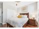 Well-lit bedroom with hardwood floors, a ceiling fan, and a large closet at 7812 Inverness Blvd, Englewood, CO 80112