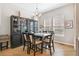 Formal dining room with elegant furnishings, including a black hutch, chandelier, and natural lighting at 7812 Inverness Blvd, Englewood, CO 80112