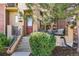 Inviting front porch with seating area, complemented by manicured landscaping and charming curb appeal at 7812 Inverness Blvd, Englewood, CO 80112
