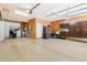 Spacious garage featuring ample storage cabinets and epoxy floors, perfect for organization at 7812 Inverness Blvd, Englewood, CO 80112