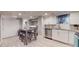 Modern basement kitchen with white cabinets, granite counters, and stainless steel appliances at 2881 W 65Th Ave, Denver, CO 80221