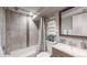 Clean basement bathroom with shower/tub combo and wood vanity at 2881 W 65Th Ave, Denver, CO 80221