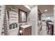 Basement bathroom with shower, toilet, and vanity; laundry and kitchen are also visible at 2881 W 65Th Ave, Denver, CO 80221