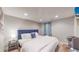 Comfortable bedroom with a king-size bed and a large window at 2881 W 65Th Ave, Denver, CO 80221