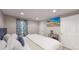 Spacious basement bedroom with a king-size bed and large window at 2881 W 65Th Ave, Denver, CO 80221
